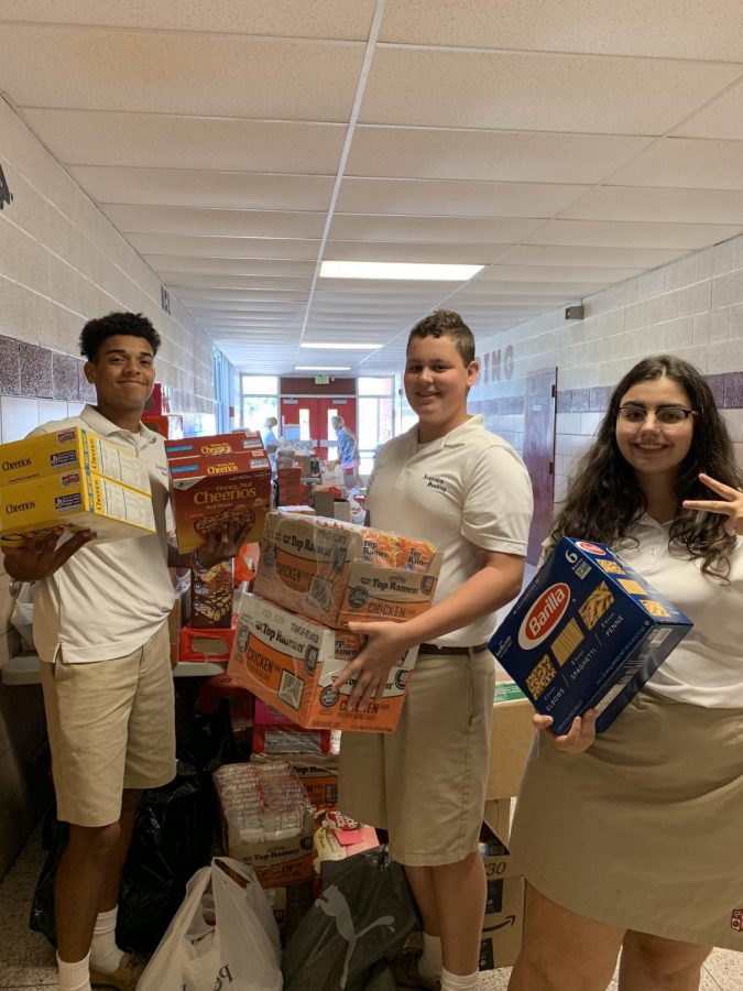Spalding Students, Matthew Kostacopoulos '21, Nico Crofton '21 and Anna Karageorgi '21 sorting the canned goods.