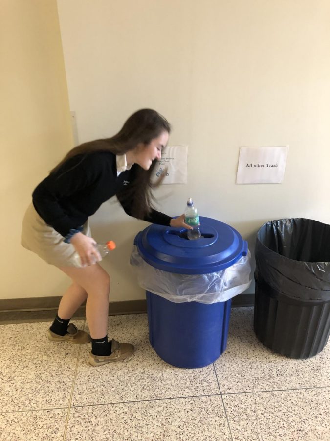Kelly Quraishi '21 is using the Green Club recycling bins to tidy up the schools.